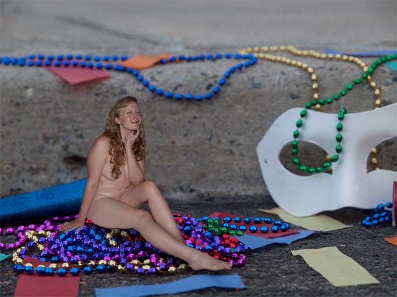 Pretty little nude elf sitting on a pile or beads